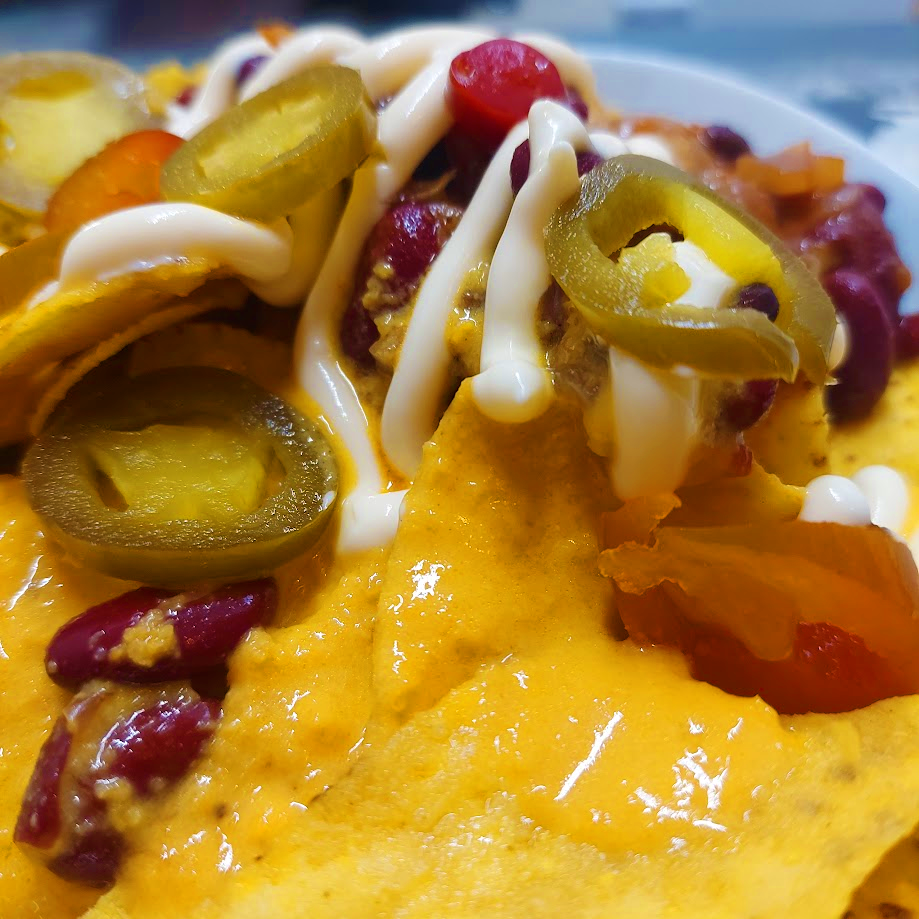 Vegan Nachos topped with Cheeze Louise Cheeze Sauce